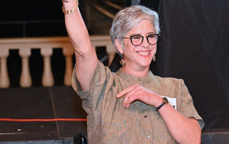 A person raising a glass in a toast at the event